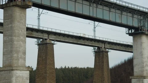 Freight train rides on a long railway bridge Stock Footage 123409588