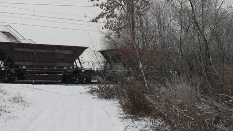 Freight train rides by rail in winter 4k Stock Footage 99360111