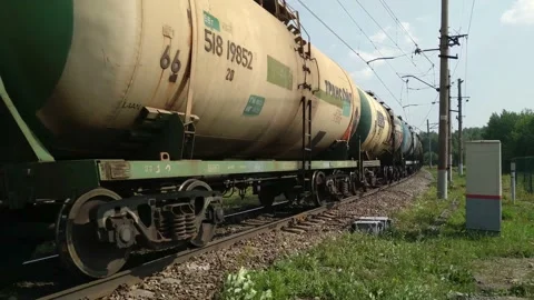 Freight train rides on rails in summer. Cargo cistern wagons move fast Stock Footage 220337514