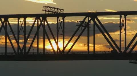 Freight train rides on the railway bridge at sunset Stock Footage 10565885