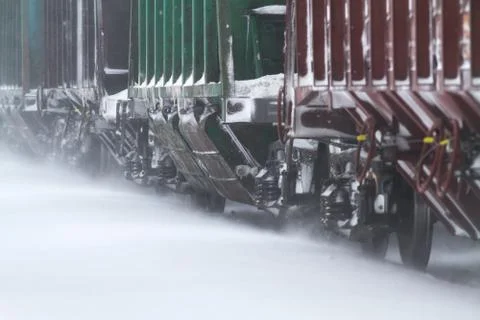 Freight train rides on the snow covered rails Stock Photos