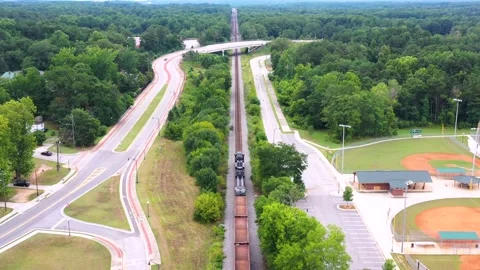 Freight train riding through a small rural town in Georgia, U.S. Stock Footage 152167341