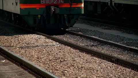 A freight train runs along the platform of the station Stock Footage 98117315