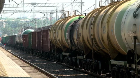 A freight train runs along the platform of the station Stock Footage 98119721