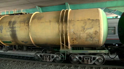 A freight train runs along the platform of the station Stock Footage 98121005