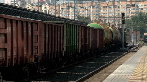 A freight train runs along the platform of the station Stock Footage 98122277