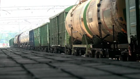 A freight train runs along the platform of the station Stock Footage 98127945