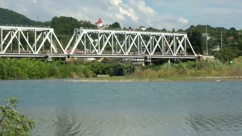 Freight train with sand rides on the railway bridge across the river Shahe Stock Footage 111163578