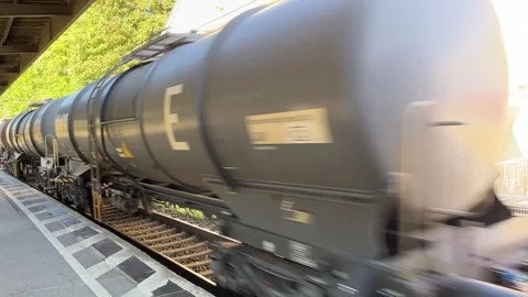 Freight Train Speeding Through a Railway Station with Oil Tankers 스톡 동영상 250896370