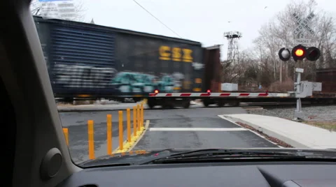 Freight train speeds through street crossing Stock Footage 45494721