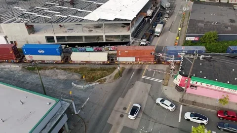 Freight Train With Stacked Shipping Containers Crossing Venables Street In Stock Footage 327619370