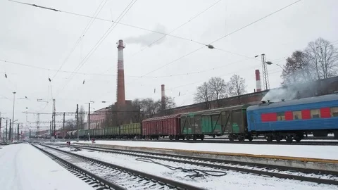 Freight Train Staying on Rail Station Platform on the Background Of Gray Sky  Stock Footage 84852101