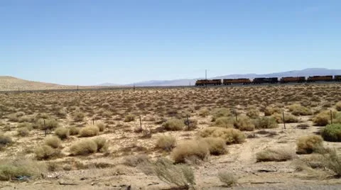 Freight train through desert -2 Stock Footage 10912987