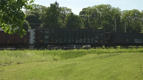 Freight train through small upstate New York town summer day Stock Footage 116334128