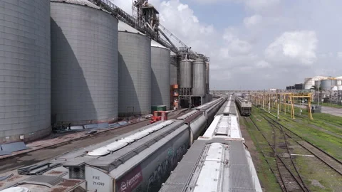Freight train transporting cargo at an industrial grain elevator complex in Video stock 345101763