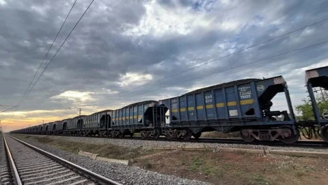 Freight Train Transporting Coal on Railway Track at Sunset. Stock Footage 331501699