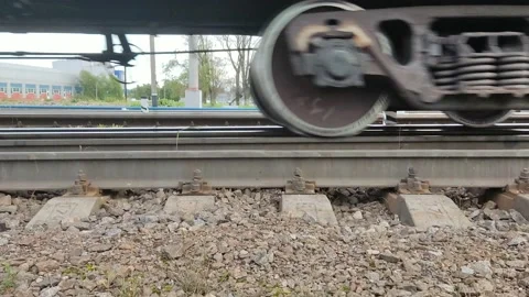 A freight train is traveling, heavy wheels, rails and sleepers are visible Stock Footage 160096429