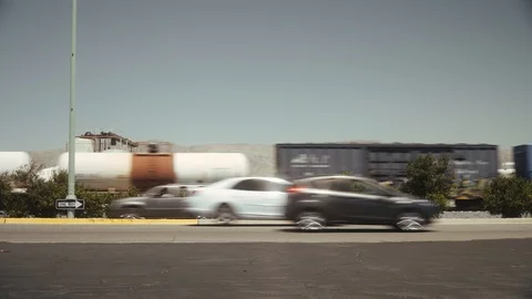 Freight train Union Pacific passing by road with mountains in background Stock Footage 112826866