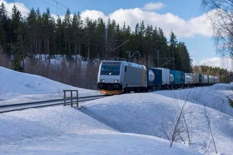 Freight train in winter landscape Stock Photos