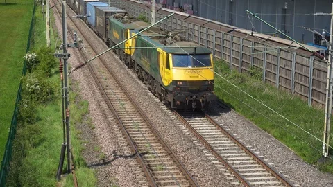 Freight trains. Freightliner electric locomotive hauled container train. UK. Stock Footage