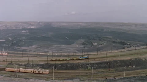 Freight trains moving through an open pit coal mine in Kazakhstan Stock Footage 330213267
