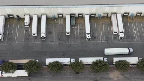 Freight truck leaving warehouse loading dock after cargo delivery Vídeos de archivo 342194919