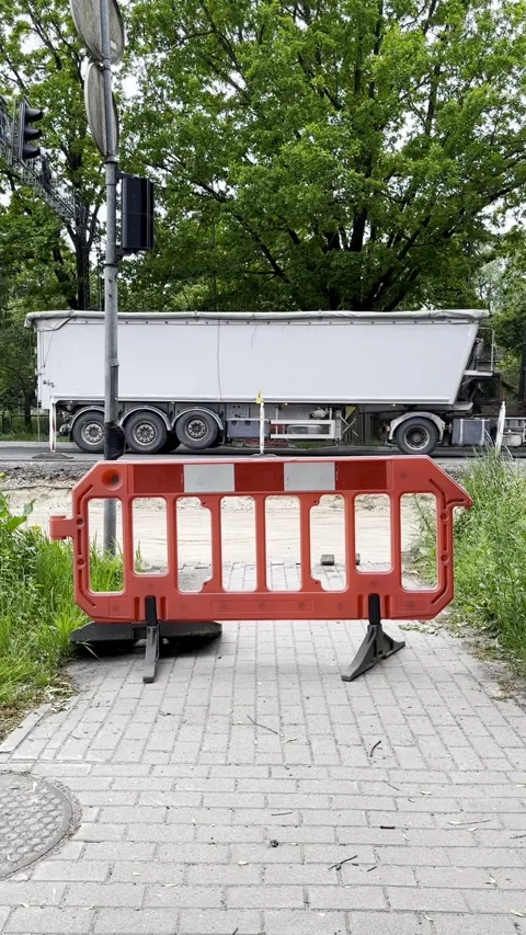 Freight Truck Passing Temporary Barrier at Urban Sidewalk Closure Stock Footage 341569230