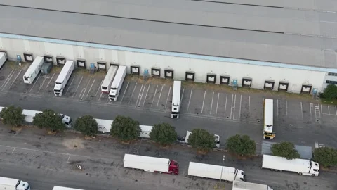 Freight trucks parked at warehouse loading docks aerial view Stock Footage 342194860