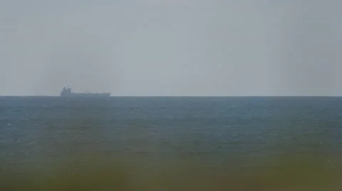 Freighter on the horizon line Stock Footage 49764075