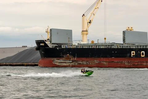 Freighter with jet ski in front 库存照片