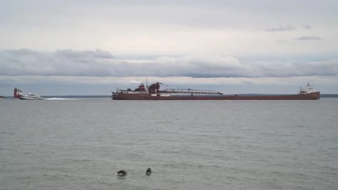A freighter passing the Round Island Lighthouse in the Straits of Mackinac Video stock 308970026