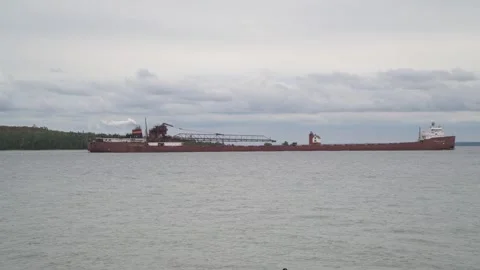A freighter passing the Round Island Lighthouse in the Straits of Mackinac Video stock 308970027