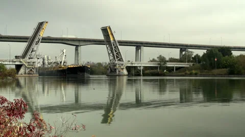 Freighter passing through open liftbridge Stock Footage 32016555