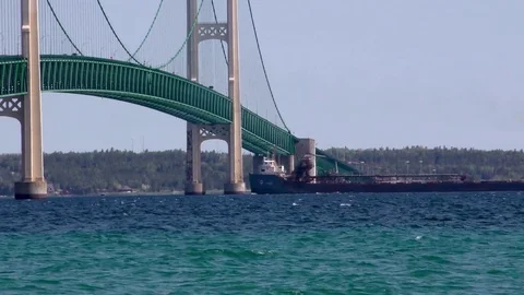 Freighter passing under the Mackinac Bridge, Michigan, USA Stock Footage 77407326