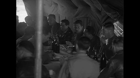 French Air Force chef jokingly chases a chicken around during World War II Stock Footage 100555217