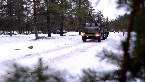French Army 155mm Howitzer CAESAR vehicles travelling along snow covered track Stock Footage 291103269
