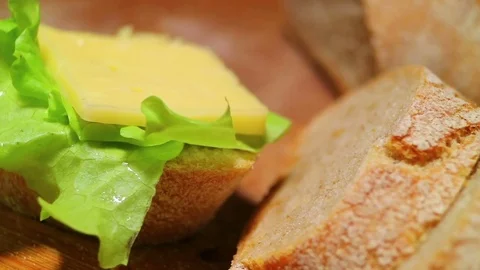 French baguette close-up. Macro view. Texture of bread. Also lettuce, cheese on  Stock Footage 84149685