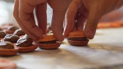 French bakery composing chocolate macarons 스톡 동영상 238502712