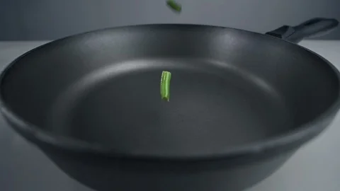 French beans are falling in slow motion to the pan, fresh vegetables are falling Video stock 120131963