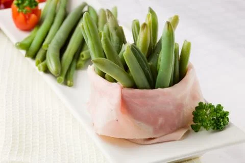French beans with wrapped ham Stock Photos