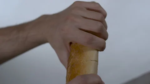 French Bread / Baguette being split in half by hands in slow motion Stock Footage 64701465