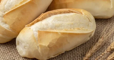 French bread, salt bread or pistolet over wooden table Stock Footage 213286158