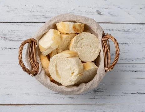 French bread, salt bread or pistolet slices over wooden table Stock Photos