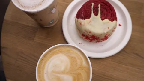 French breakfast on the table - coffee with foam and dessert cake or bun 스톡 동영상 294395852