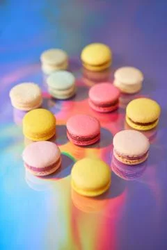 French cake macaron. Set of cute sweets on colorful rainbow background. almond Foto stock