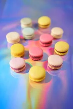 French cake macaron. Set of cute sweets on colorful rainbow background. almond Foto stock