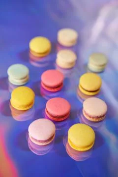 French cake macaron. Set of cute sweets on colorful rainbow background. almond Foto stock