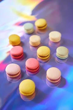 French cake macaron. Set of cute sweets on colorful rainbow background. almond Foto stock