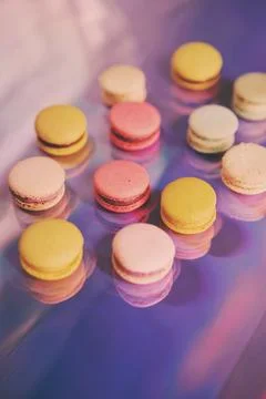 French cake macaron. Set of cute sweets on colorful rainbow background. almond Foto stock