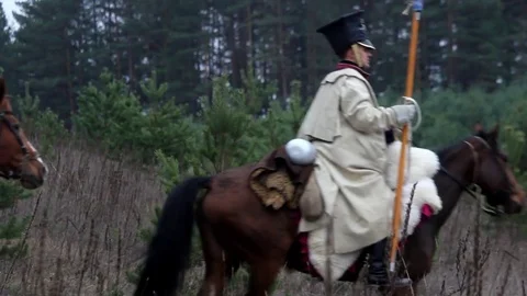 French cavalrymen with lances and weapons ride through the forest on horses,  Video stock 79822258